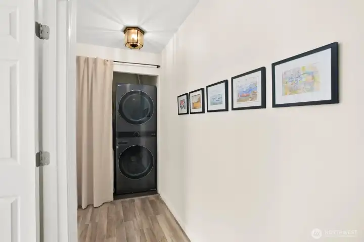 Laundry area with top of the line energy star full sized stacked washer and dryer