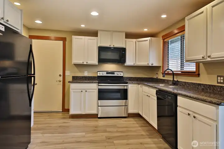 The door leads to the garage with laundry hookups.