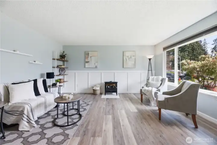 Spacious living room with picture window, new flooring and lots of natural light