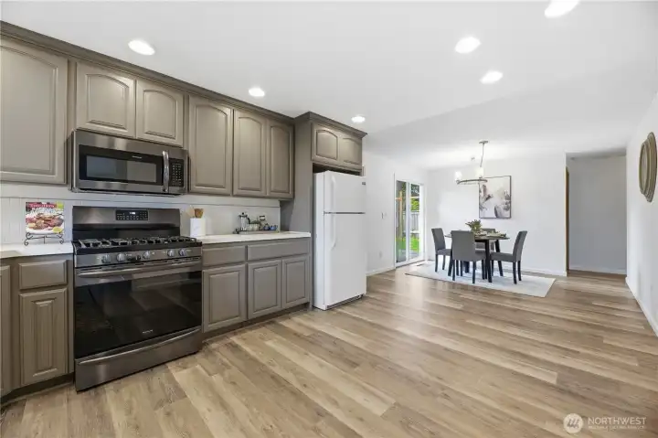 Kitchen opens to dining, gas range