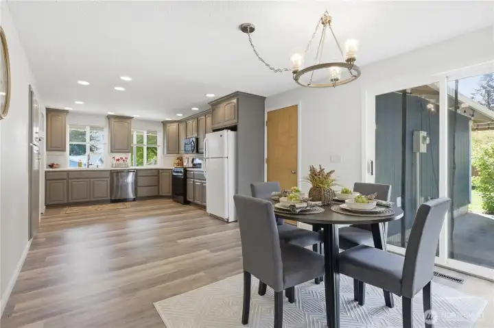 Dining with sliding doors to patio and large, fully fenced yard