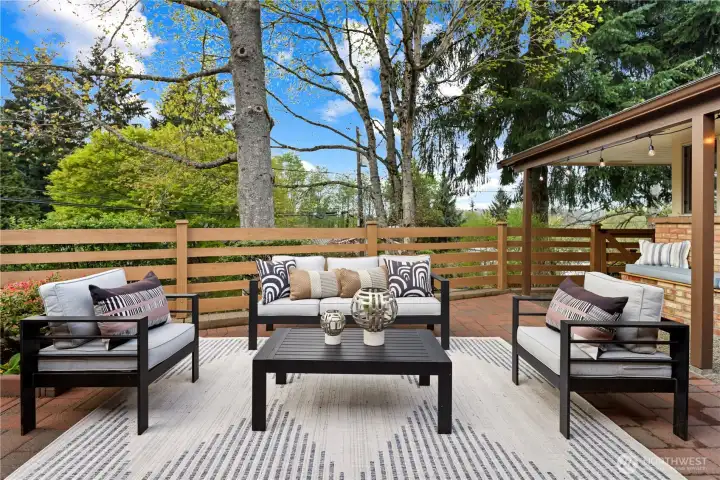 Great size for cozy outdoor living furniture and a fire table. Custom paver patio with bench seat and built-in flower bed near the front door.