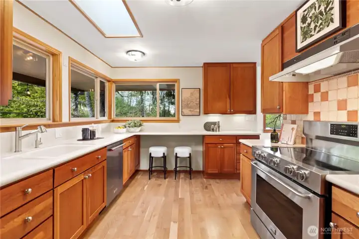 Kitchen with stainless appliances, warm cabinetry, and everyday functionality
