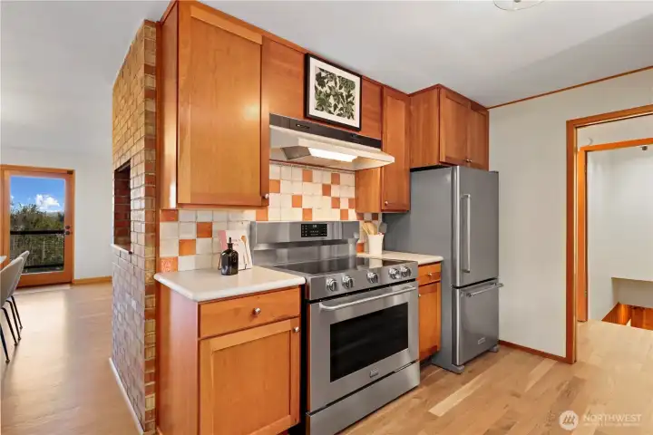 Cherry cabinets, lots of pull-out shelves in the cabinets, baker's rack, stainless steel appliances, and new wood floors thoughout the main level to match the existing original bedroom harddwoods.