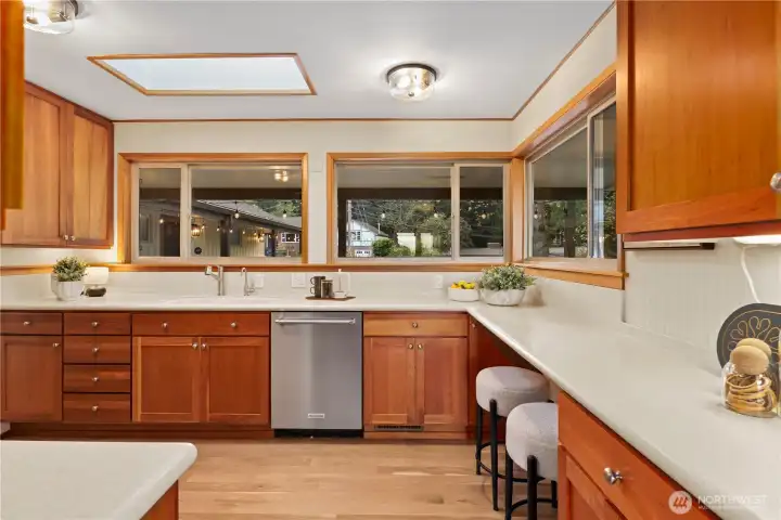 Kitchen looking to the front patio. New skylight, fresh paint, updated light fixtures and bar seating.