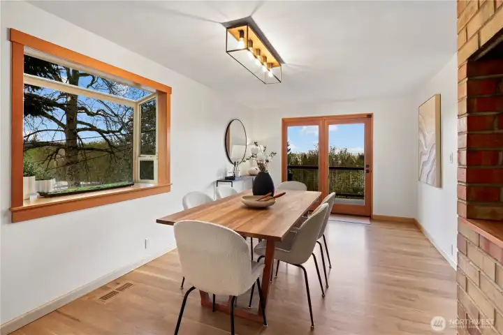 Spacious dining room with sunny garden window, views east, with direct access to the upper deck. On the right, there was originally a rotisserie for the chimney stack.