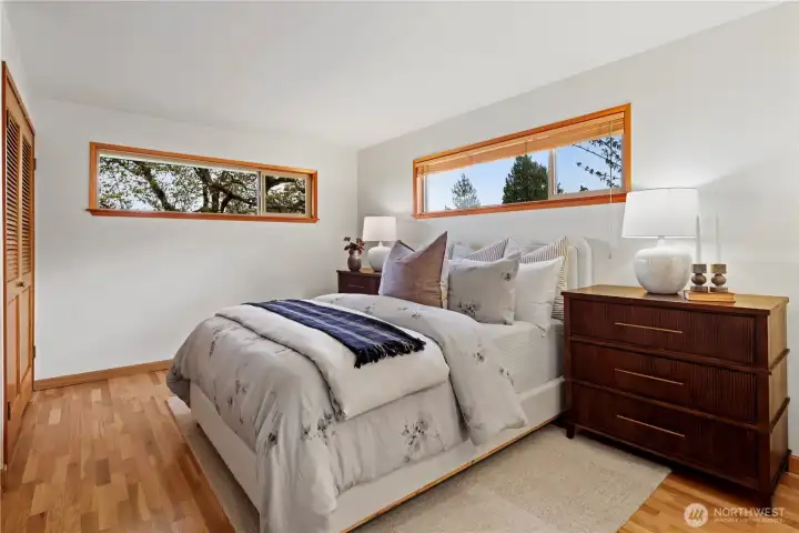Primary bedroom accommodates larger furniture with flexible layout options. Wait until you see what's possible with larger windows looking east to the view.