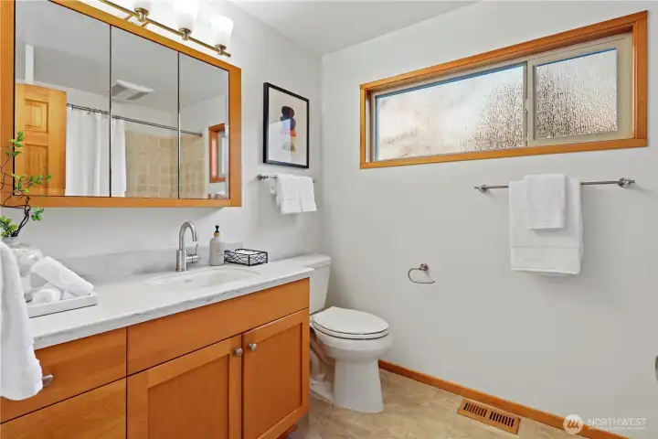 Main-floor full bathroom. Spacious with oversized vanity and tub/shower combo.