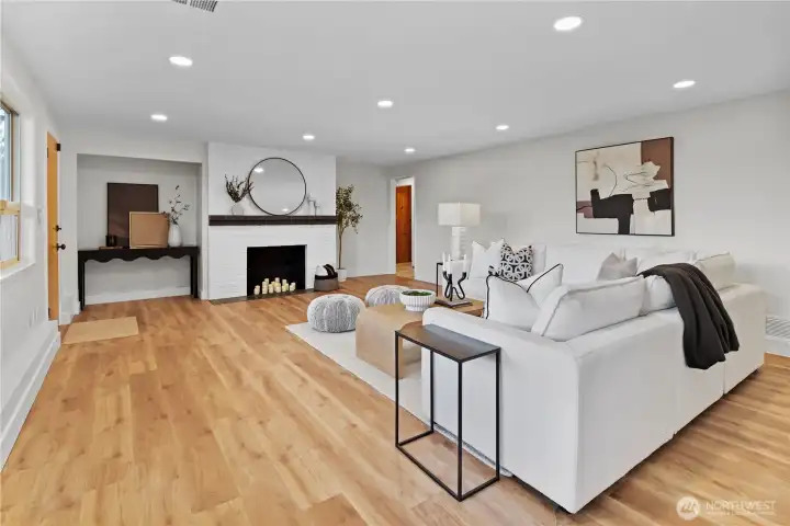 Large rec room with updated flooring, lighting, basebaord, paint, and modernized comfort.