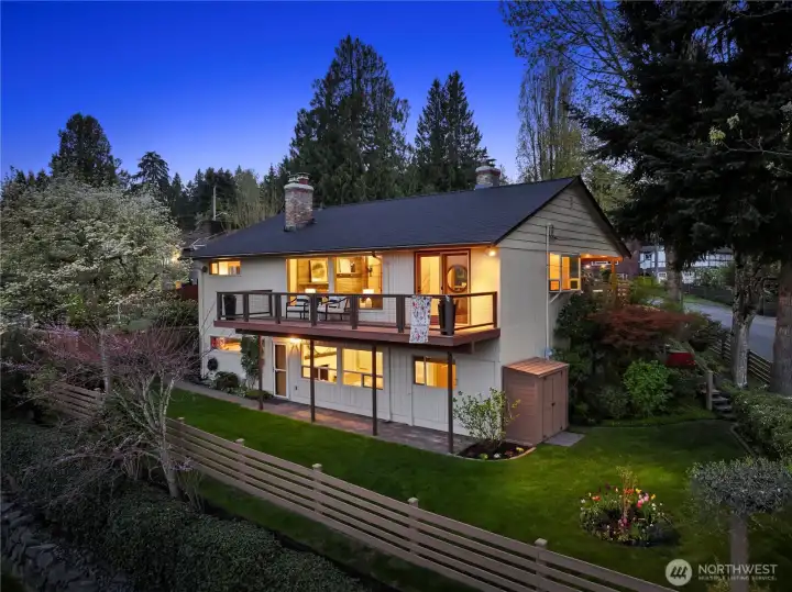 Such a charming home all lit up in the evening. All exterior lighting set to automatic timers. Sprinkler system in backyard beds and hose system on side yard with timers for easy maintenance.