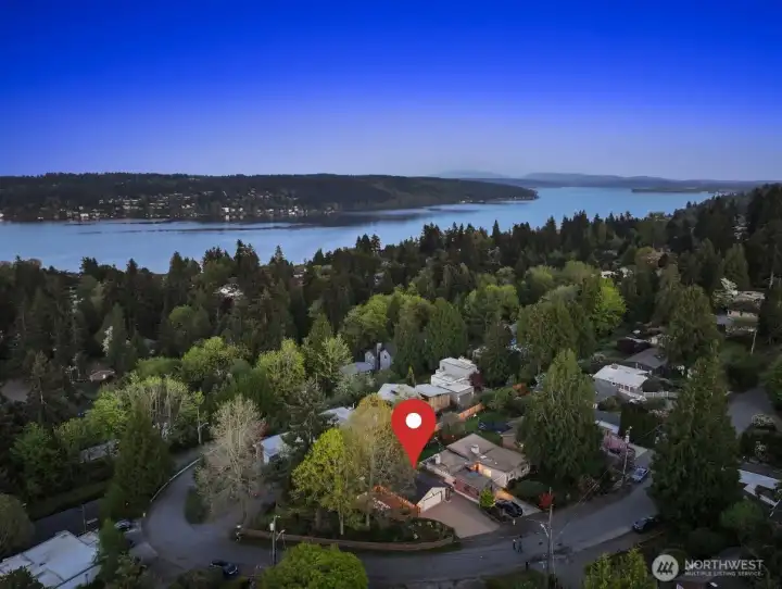 You can see the light-colored garage where this home's paver driveway leads. Perched atop the pinnicle of the hill as the street rounds the corner. Close to Lake Washington and within the boundary to apply for an associate membership to Sheridan Beach Club. Waiting list is long, but well worth it.