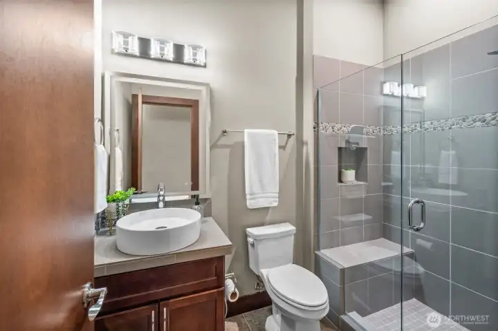Hall bath next to second bedroom with LED lit mirror, glass shower with bench, and a stylistic sink! Hall bath next to second bedroom with LED lit mirror, glass shower with bench, and a stylistic sink!