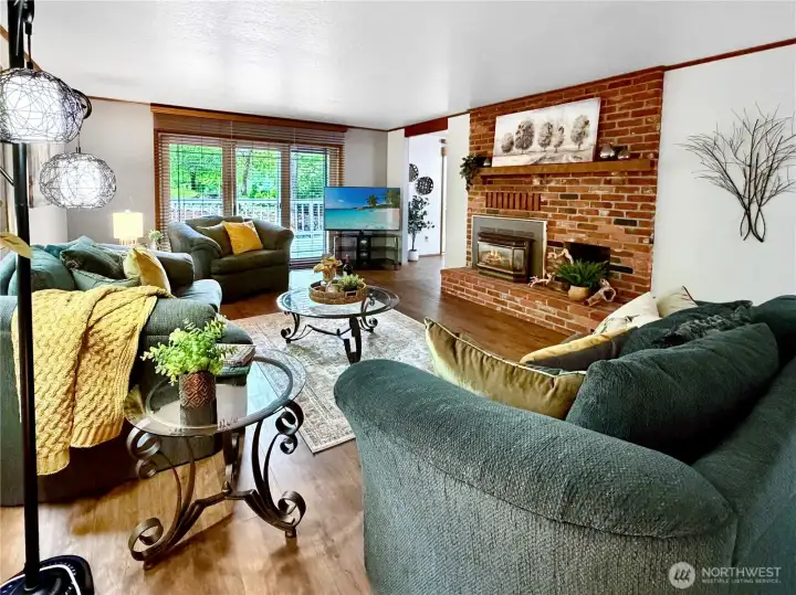 Gas fireplace in lovely brick surround keeps things cozy.