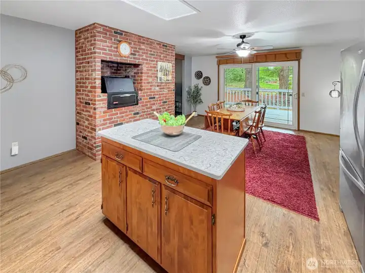 Kitchen dining features brick accent wall with built-in grill.  Large slider offers access to deck extending your living space to the private rear yard.