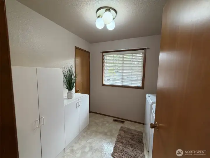 Large laundry with closet and lots of room for storage