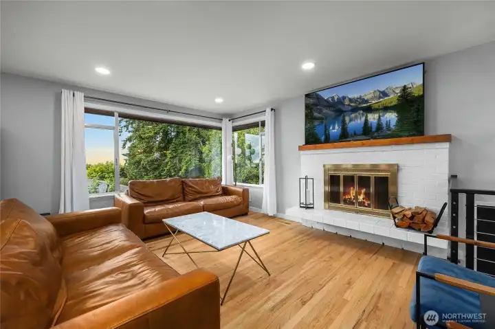 The living area features a cozy fireplace, large picture windows and ample room for seating.