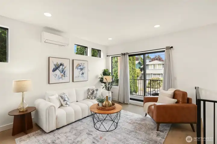 Spacious living room with direct access to the covered deck overlooking the fully fenced front yard Spacious living room with direct access to the covered deck overlooking the fully fenced front yard