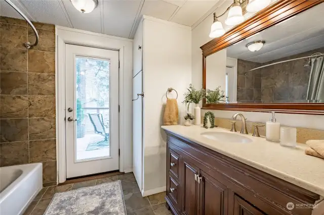 Fantastic updated primary bath tiled shower & floors, new lighting and vanity. Even an outside door to back deck.