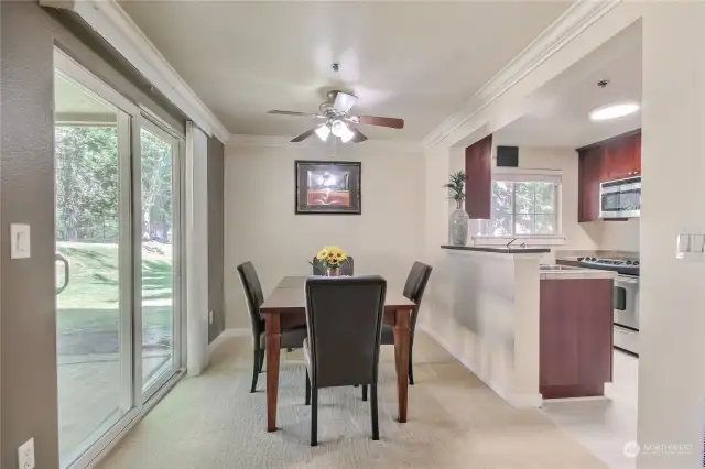 Dining room and kitchen overlook greenbelt. Sliding glass door opens up to private patio that overlooks greenbelt.