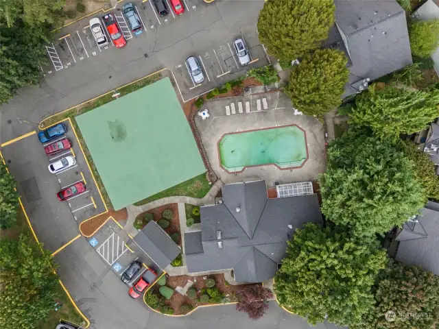 Drone photo of clubhouse, pool sports court and guest parking area.