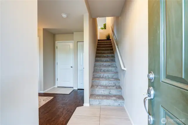 Ground floor entry with flex room/office to the left, half bathroom, garage entry & stairs to the main living space. Brand new carpet & interior paint.