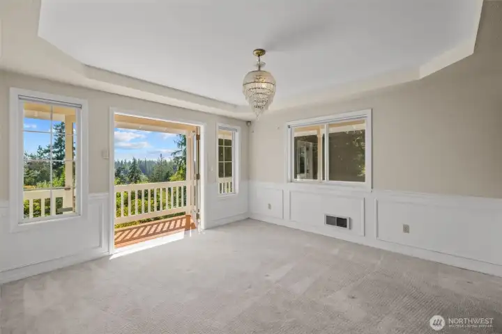 A light filled dining room off the kitchen with walk out to the deck and epic view.
