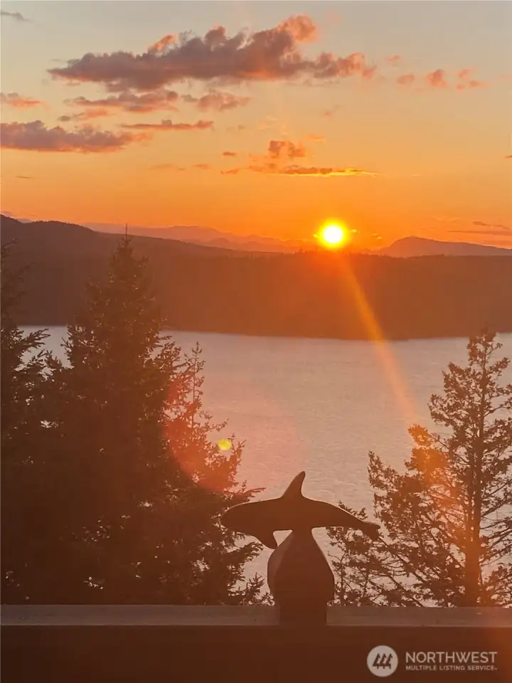 Sunset across Eastsound Bay, with Canada as a back drop. This photo was taken off the deck of this high bank waterfront home.