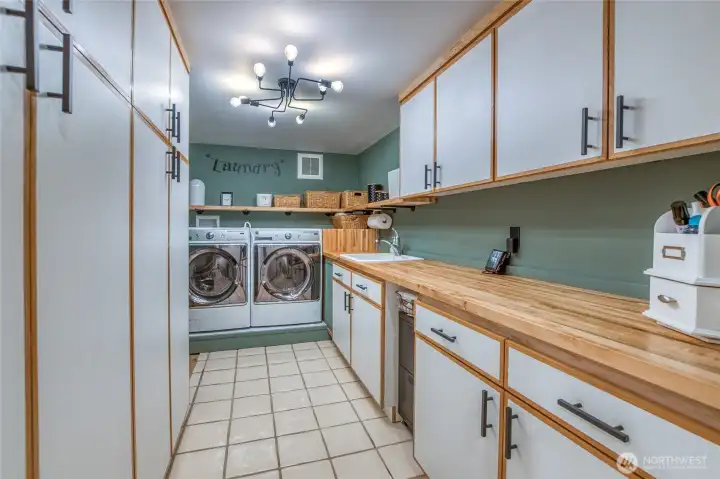 Large laundry room off the kitchen area offers plenty of storage and counter space.