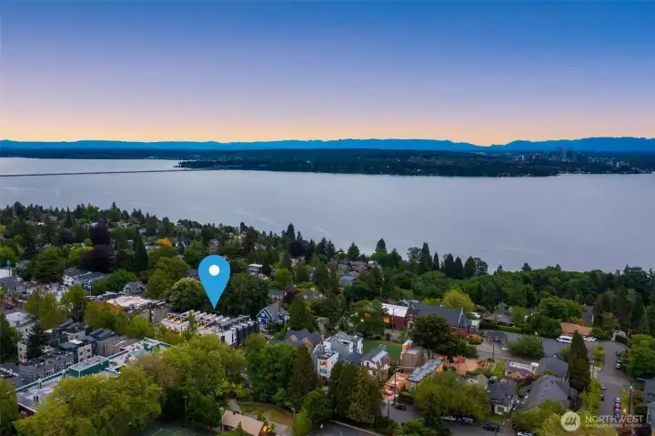 Sweeping aerial shot of the Madrona neighborhood, where modern residences nestle between evergreen hills and city skyline.