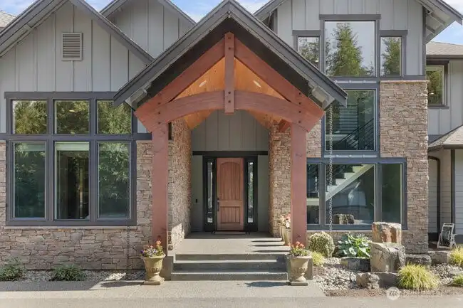 Picturesque entry with ached beams, tall ceilings with Blue Pine and bubbling rock fountain. The curb appeal is unmatched.