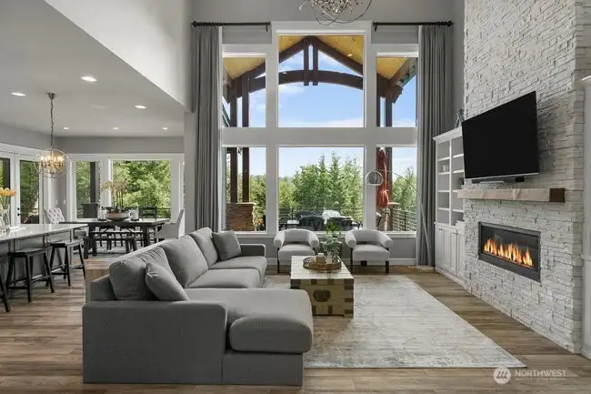 22 foot floor to ceiling stone fireplace and view windows in large Great Room space with a beautiful chandelier and gorgeous view of the Mt. Rainier.