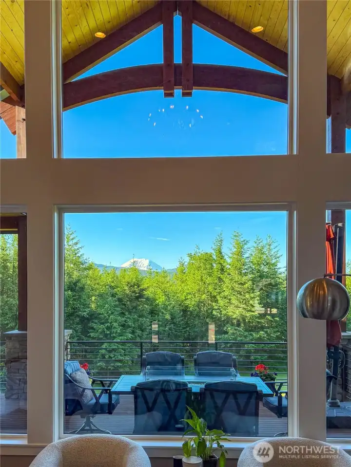 Picture view window looks out to the entertainment space, the dramatic arched beams, Mount Rainier and territorial views.