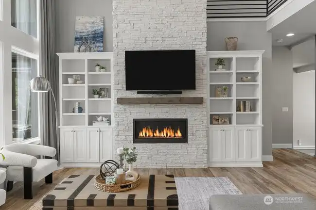 Stone floor to ceiling fireplace with builtins.