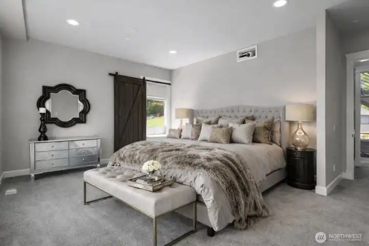 Main floor luxurious primary suite with all the bells and whistles including a retractable movie screen.