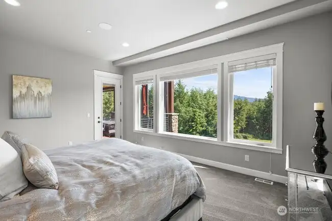 Main floor luxurious primary suite with all the bells and whistles including a retractable movie screen.