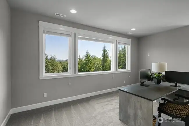 Spacious view office with spiral staircase to Primary bathroom.