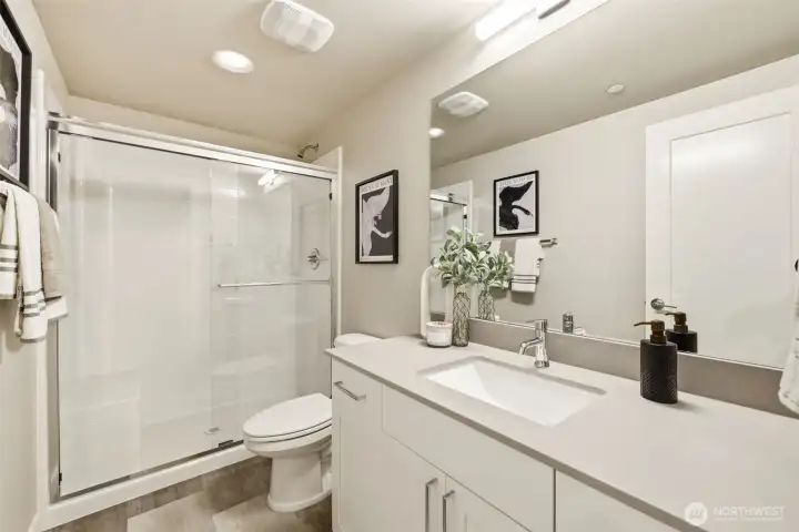 Stylish lower-level bathroom with walk-in shower, perfect for guests or daily use