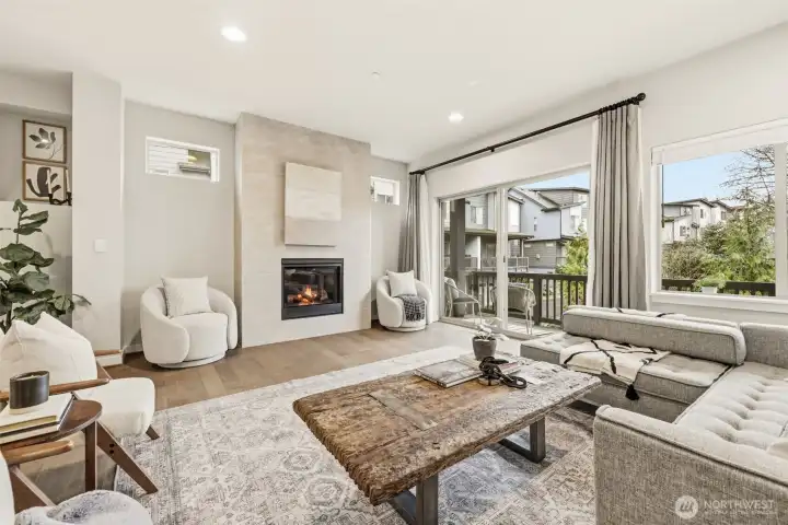 Main floor living room anchored by a modern gas fireplace