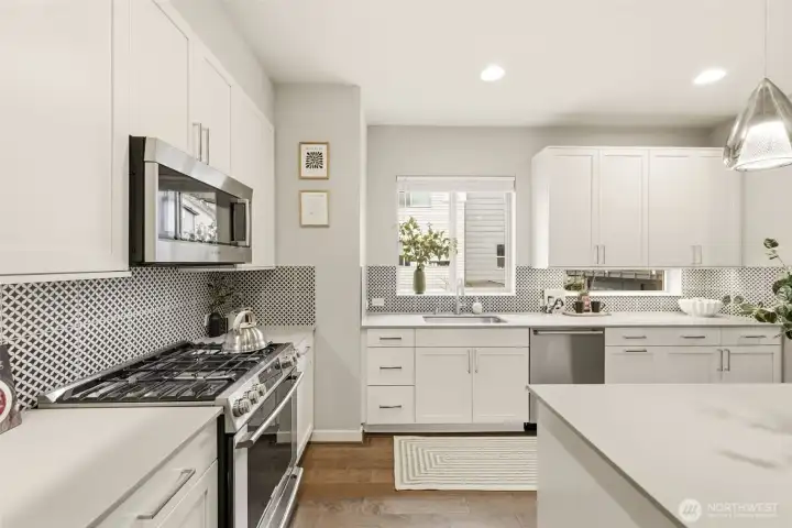 Open-concept kitchen with seamless flow into dining and living areas