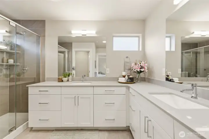 Elegant primary bathroom with dual vanity and modern fixtures