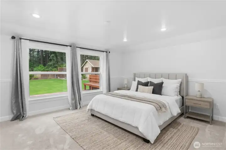 Primary bedroom that looks out to the back yard. Virtually staged. Primary bedroom that looks out to the back yard. Virtually staged.