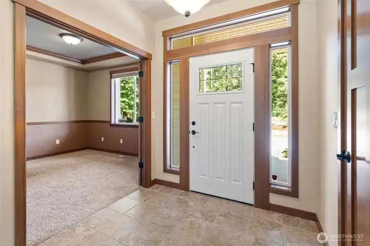 Beautiful glass surrounds the front door allowing amazing natural light to pour in.
