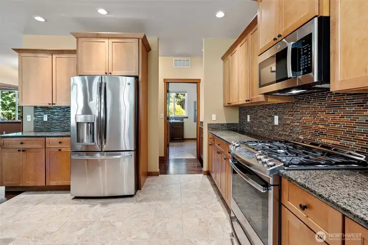 Incredible access to the laundry room and 3 car garage through the back of the kitchen.