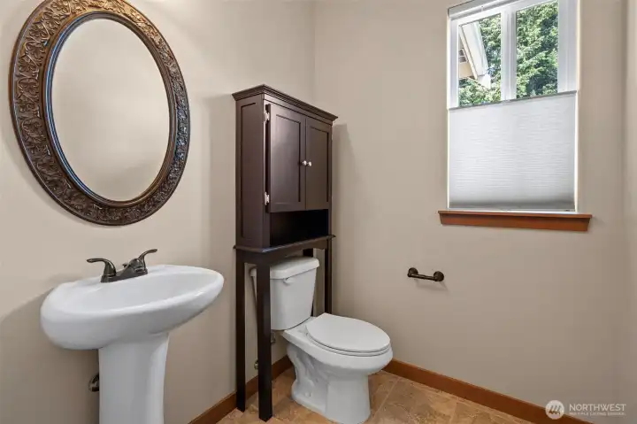 Half bath down the hallway from the laundry and behind the kitchen.