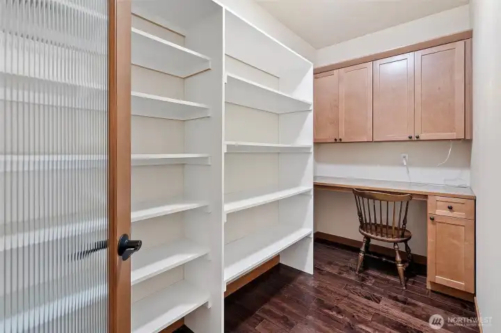 Motion detecting lighting and privacy glass adorn this extra large walk in pantry!