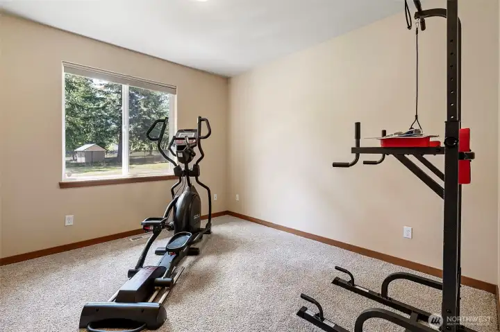 2nd bedroom in the east wing has been used for a home workout space.