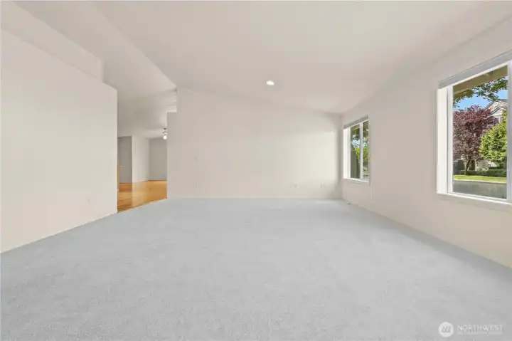 Step into a light-filled living space featuring vaulted ceilings, skylights, crisp white trim, and a large bay window that brings in beautiful natural light throughout the day. The open concept layout creates an inviting flow ideal for both everyday living and gathering with guests. Step into a light-filled living space featuring vaulted ceilings, skylights, crisp white trim, and a large bay window that brings in beautiful natural light throughout the day. The open concept layout creates an inviting flow ideal for both everyday living and gathering with guests.