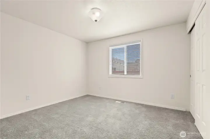 No Virtual Staging: This secondary bedroom offers flexibility for guests, hobbies, or a home office, with comfortable proportions and natural light that create an inviting atmosphere. No Virtual Staging: This secondary bedroom offers flexibility for guests, hobbies, or a home office, with comfortable proportions and natural light that create an inviting atmosphere.