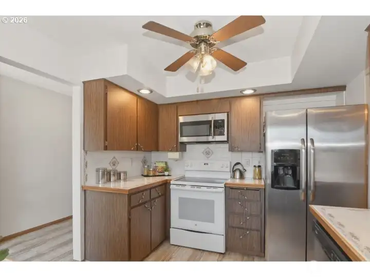 Stainless steel appliances. Refrigerator, dishwasher, built in microwave, oven. Tile countertops.