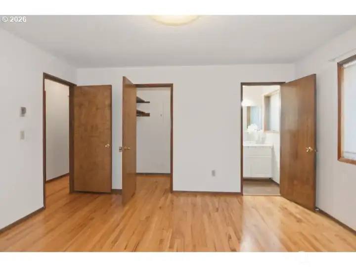 Primary bedroom with attached bathroom and walk in closet.